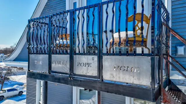 a view of a house with a yard covered with snow in the background