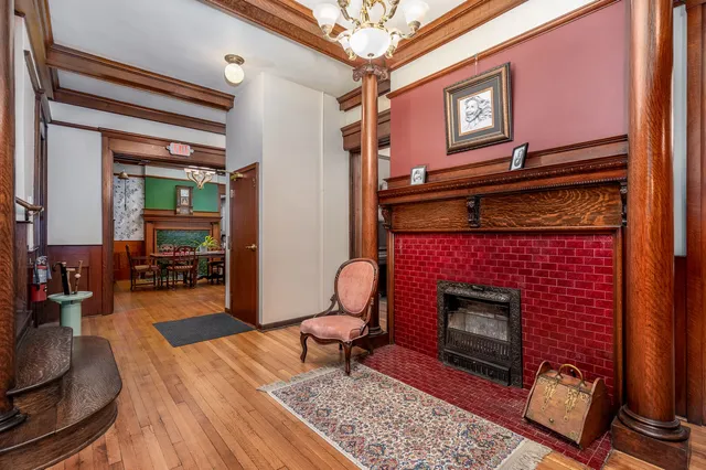 a dining room with furniture a fireplace and wooden floor