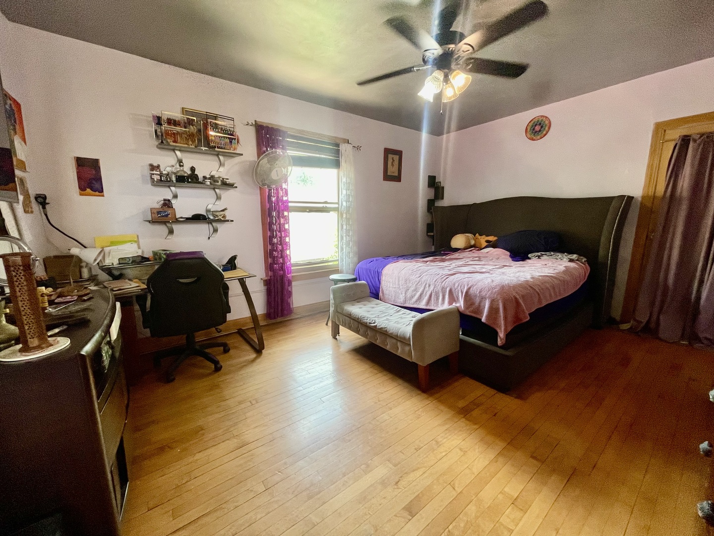 7916 South Constance Avenue Chicago, IL 60617 - Photo 25 of 28 a bedroom with a bed and a chandelier