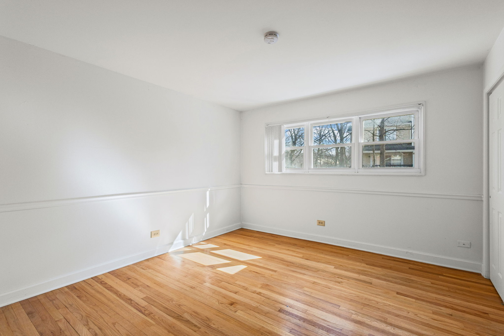 169 East Palatine Road, Unit E Palatine, IL 60067 - Photo 15 of 24 an empty room with wooden floor and windows