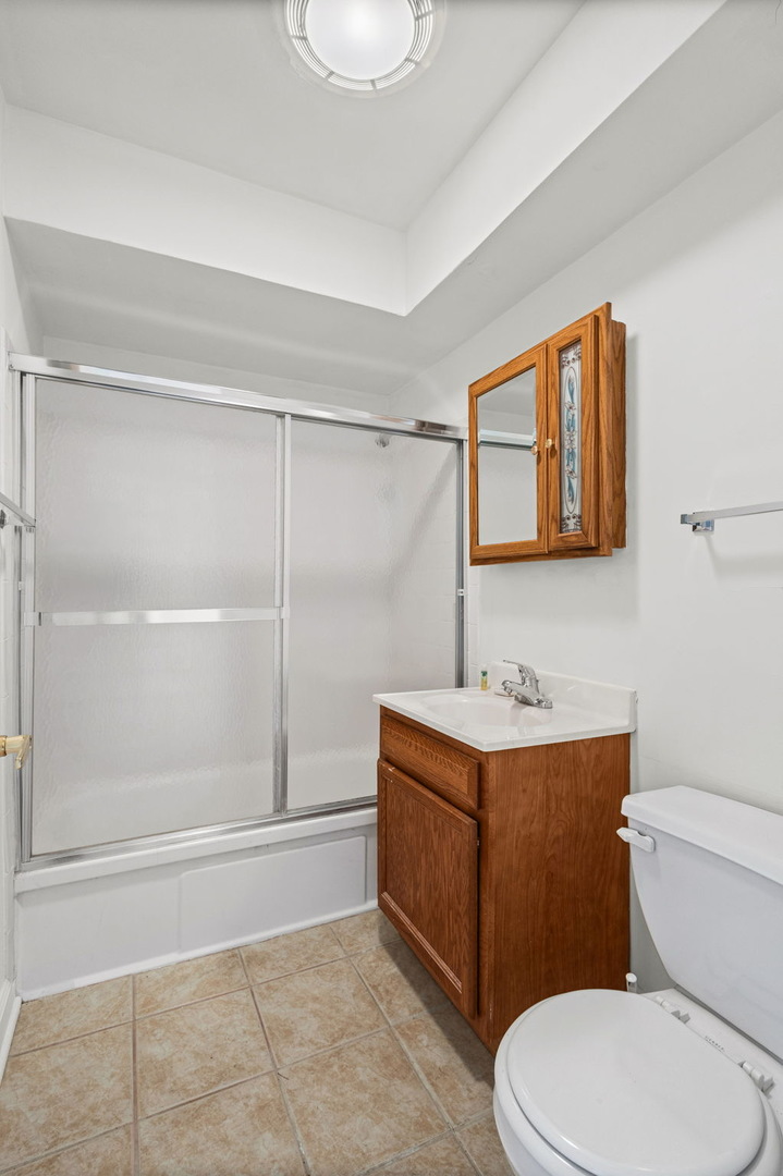 169 East Palatine Road, Unit E Palatine, IL 60067 - Photo 18 of 24 a bathroom with a sink a toilet and shower