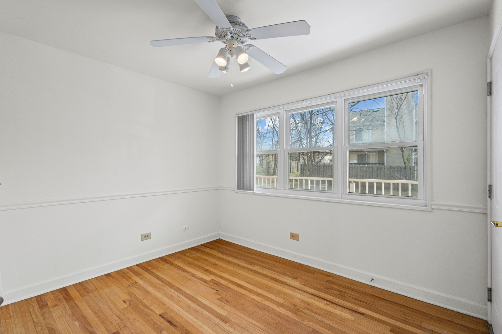 169 East Palatine Road, Unit E Palatine, IL 60067 - Photo 4 of 24 a view of empty room with wooden floor and fan