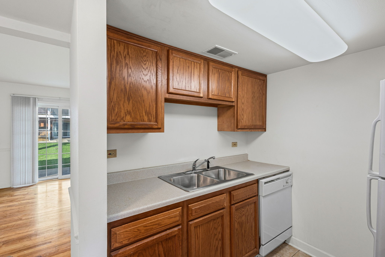 169 East Palatine Road, Unit E Palatine, IL 60067 - Photo 6 of 24 a kitchen with wooden cabinets and a sink