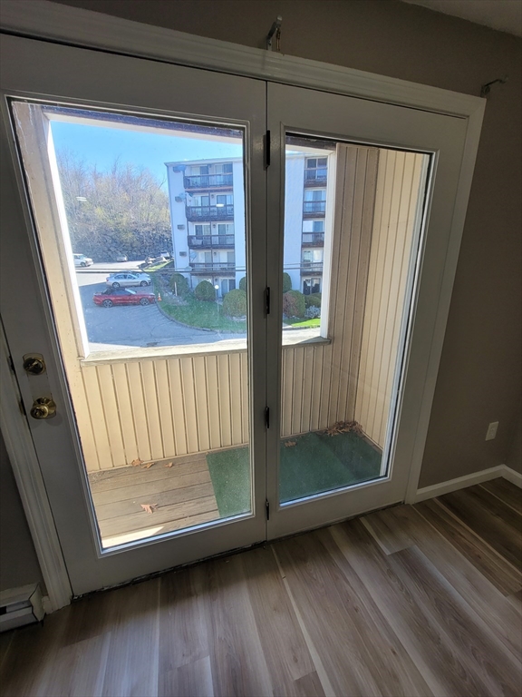 7 Gibbs Street, Unit 7 Worcester, MA 01607 - Photo 19 of 20 a view of a room with wooden floor and windows