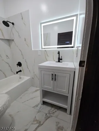 a bathroom with a sink a toilet and mirror