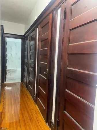a view of walk in closet with wooden floor