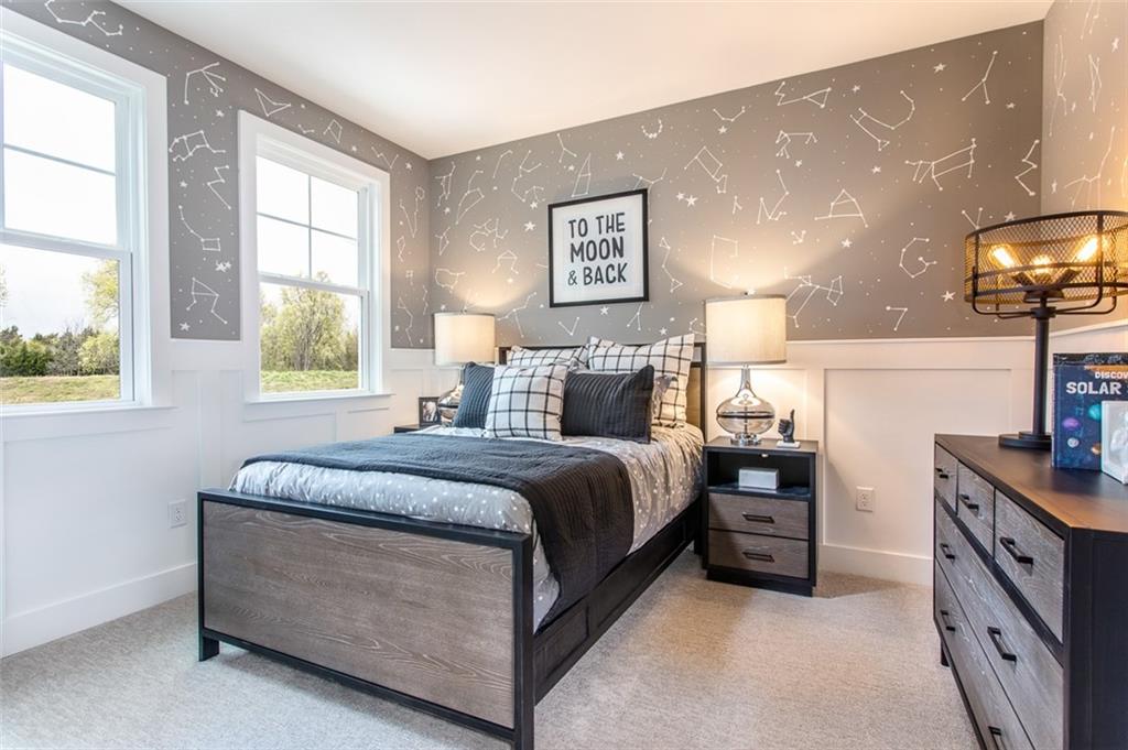 4840 Montane Street Cumming, GA 30028 - Photo 12 of 34 a spacious bedroom with a bed and a lamp on dresser next to a window