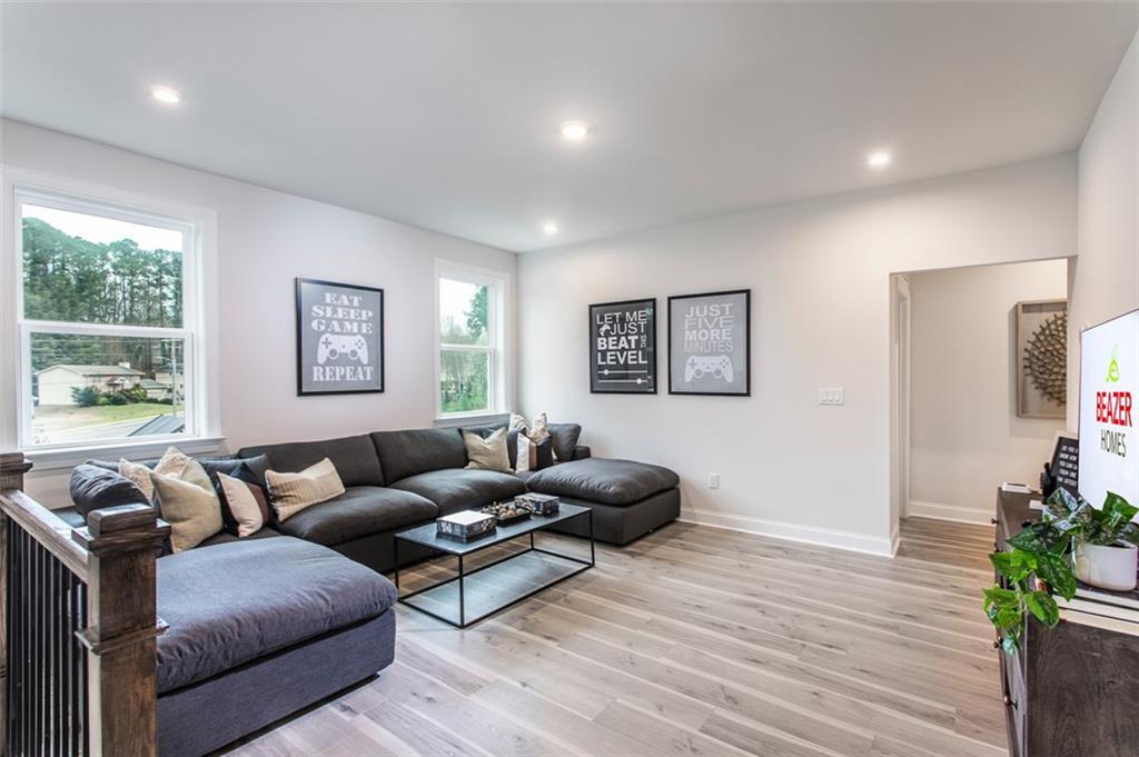 4840 Montane Street Cumming, GA 30028 - Photo 15 of 34 a living room with furniture and a hard wood floor