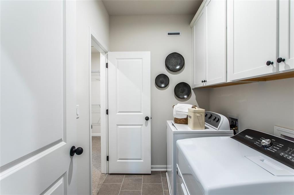4840 Montane Street Cumming, GA 30028 - Photo 19 of 34 a bathroom with a sink and a washing machine