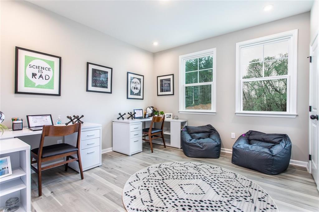 4840 Montane Street Cumming, GA 30028 - Photo 24 of 34 a living room with furniture and a window