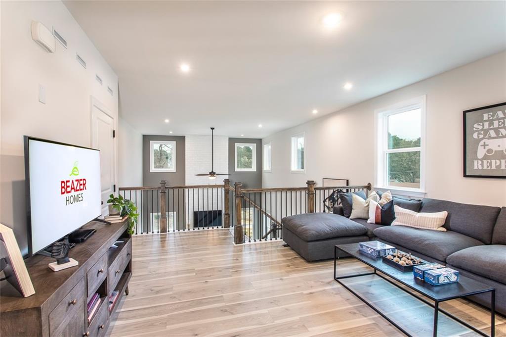 4840 Montane Street Cumming, GA 30028 - Photo 6 of 34 a living room with furniture and a flat screen tv