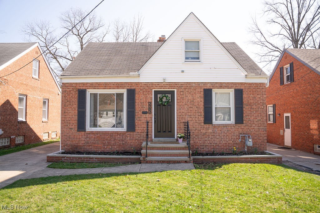 2707 Hearthstone Road Cleveland, OH 44134 - Photo 1 of 49 Bungalow-style home with a shingled roof, a chimney, a front yard, and brick siding