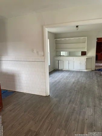 a view of a room with wooden floor