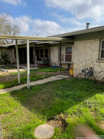 a view of a house with backyard sitting area and garden