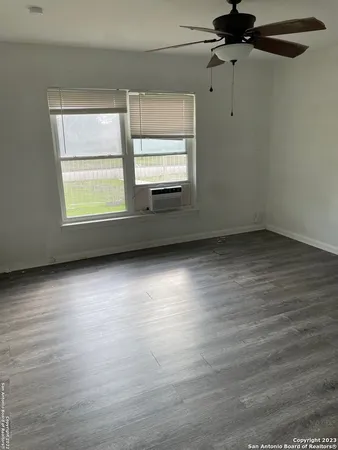 wooden floor in an empty room with a window