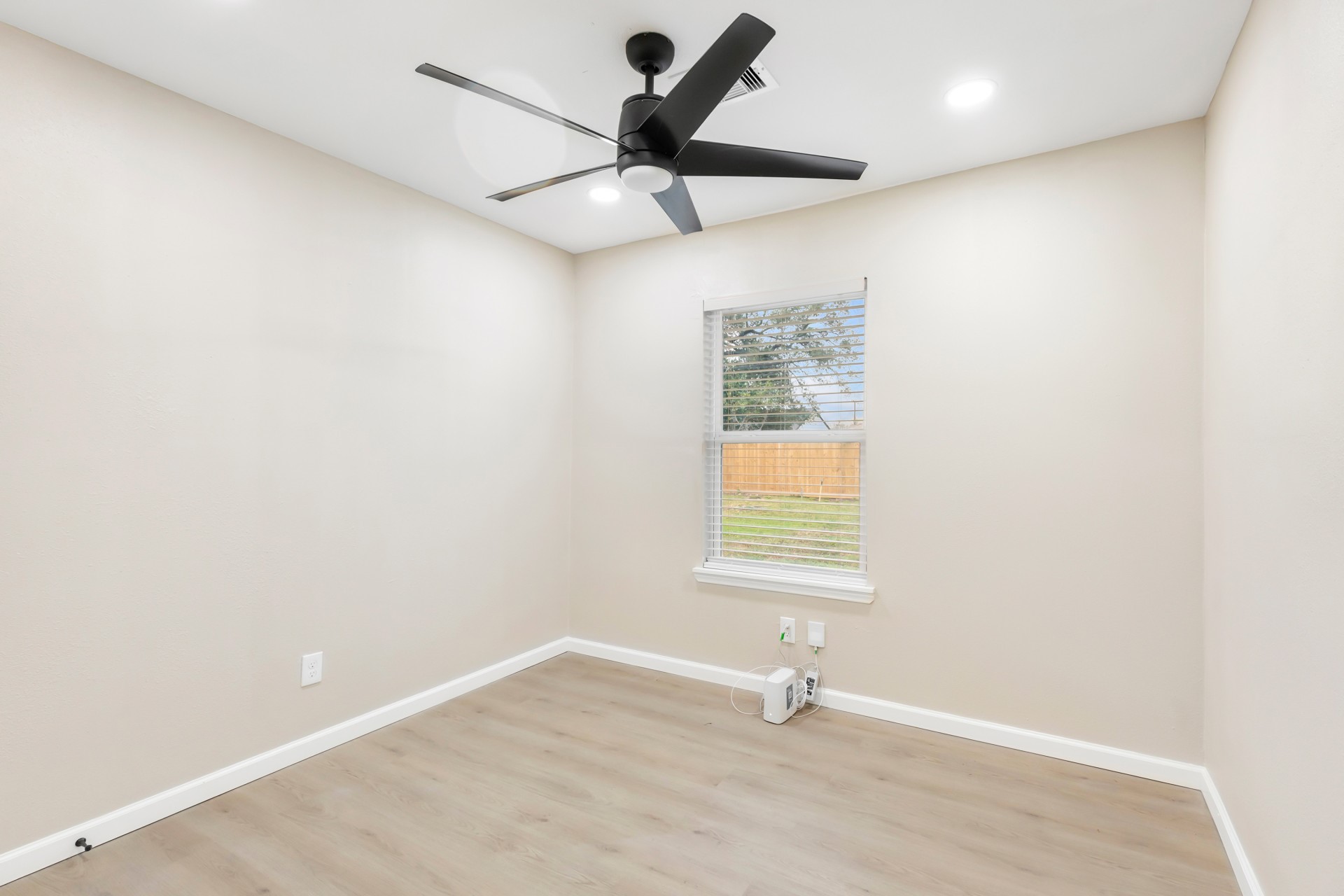 4231 Hartsville Road Houston, TX 77047 - Photo 13 of 23 an empty room with wooden floor and windows