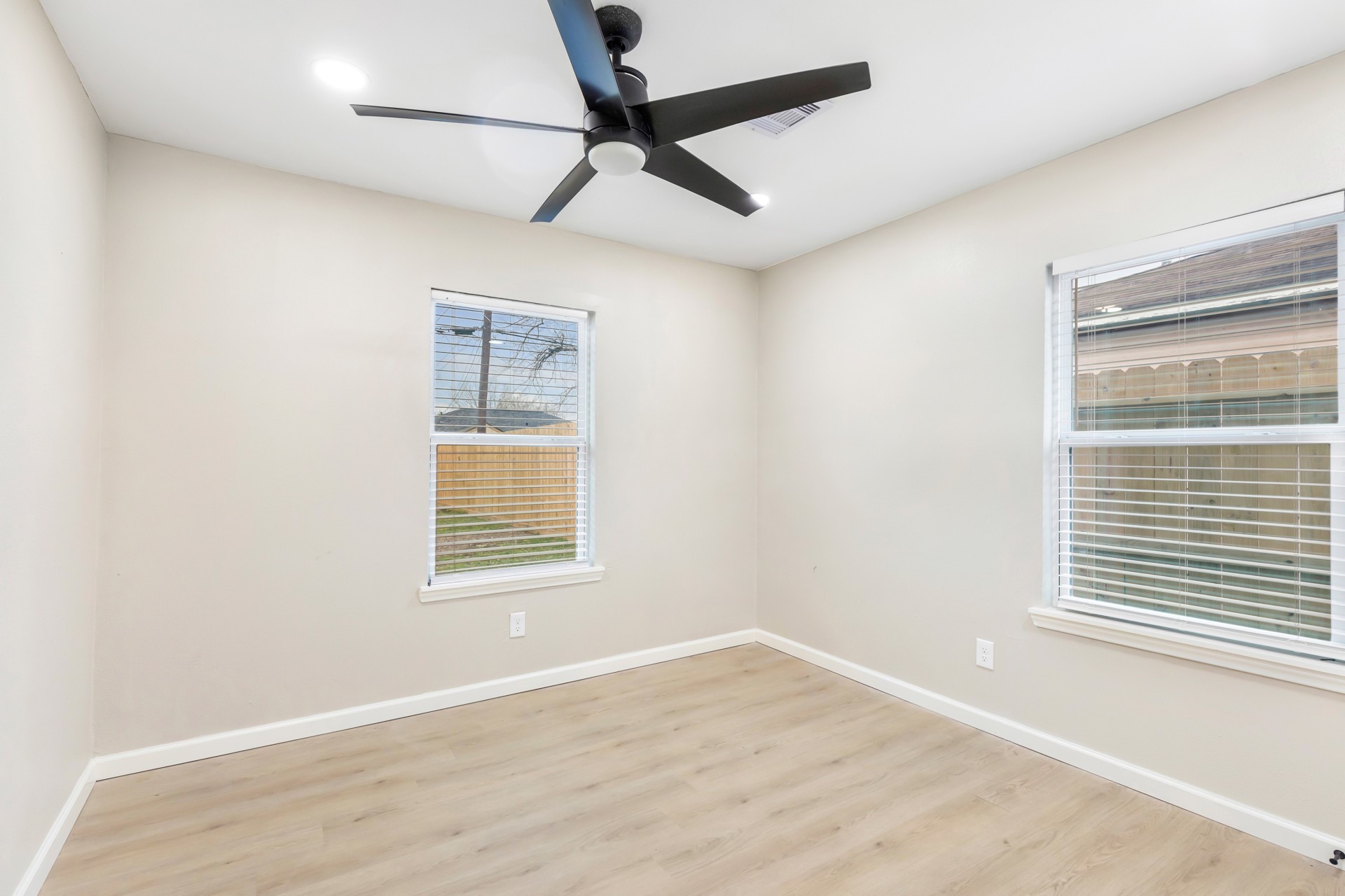 4231 Hartsville Road Houston, TX 77047 - Photo 16 of 23 a view of an empty room with a window and wooden floor