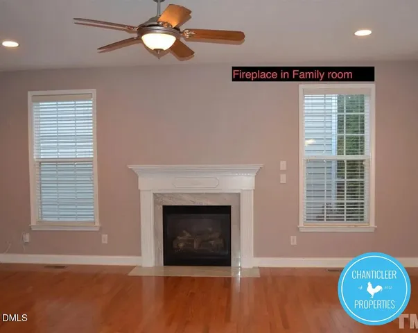 a view of a livingroom with a fireplace and window