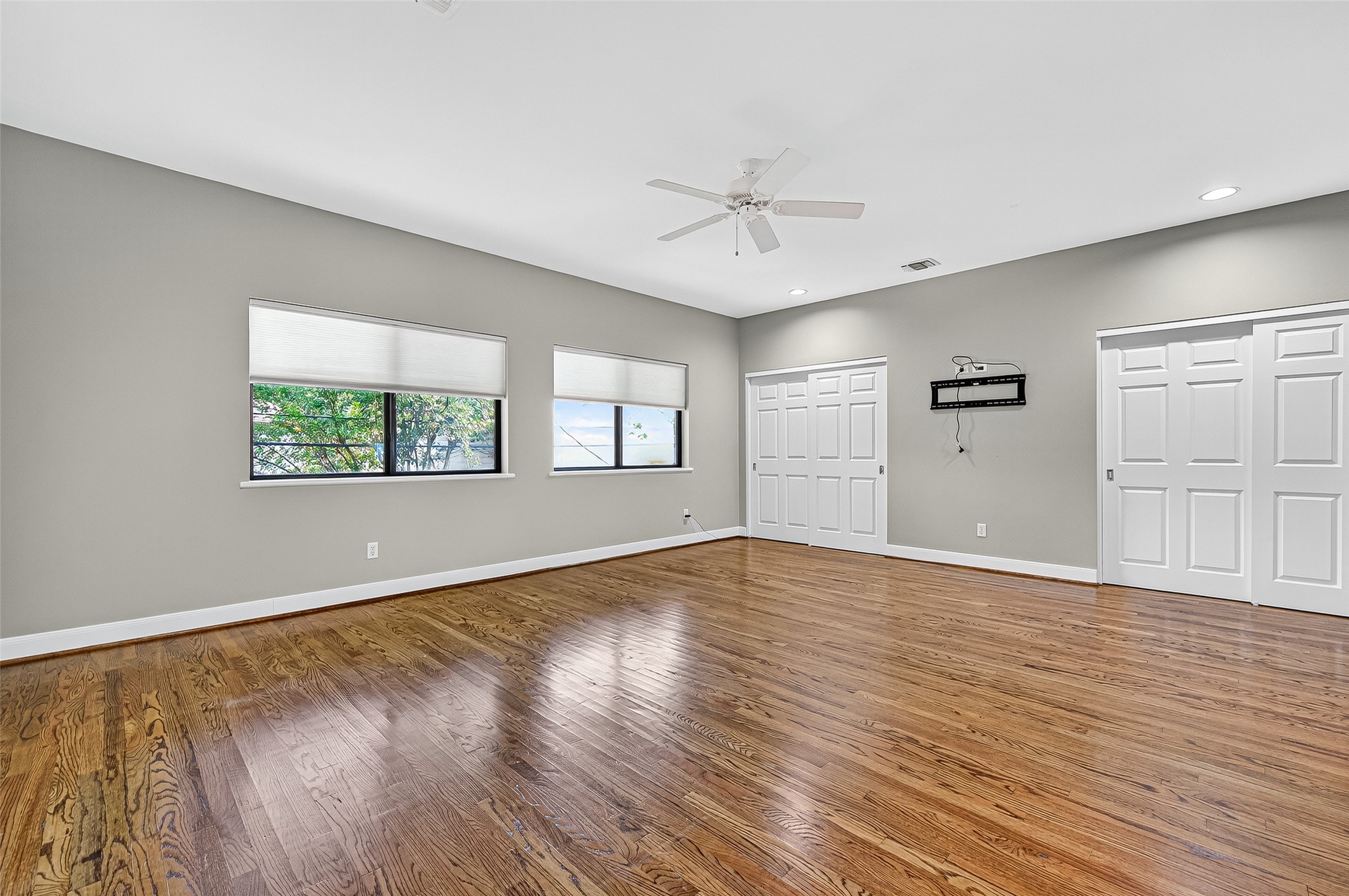 3027 Bissonnet Street Houston, TX 77005 - Photo 37 of 47 Primary bedroom with hardwood floors and large windows — plenty of room for a king bed
