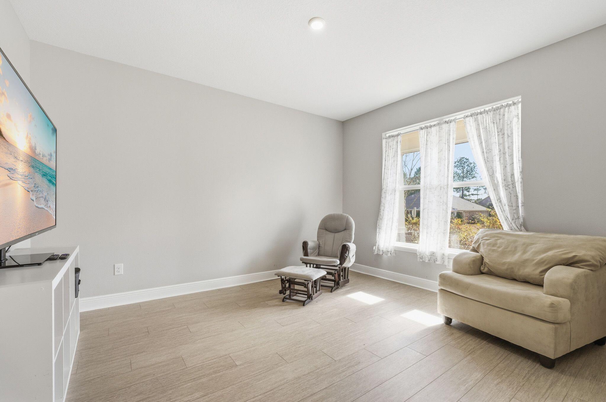 334 Tournament Lane Freeport, FL 32439 - Photo 11 of 27 a living room with furniture and a large window