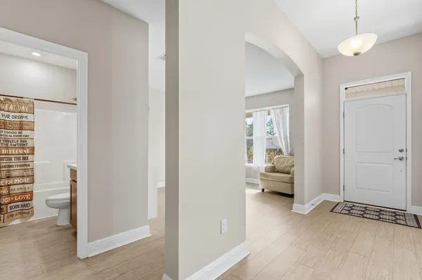 a bedroom with a bed a window and dresser