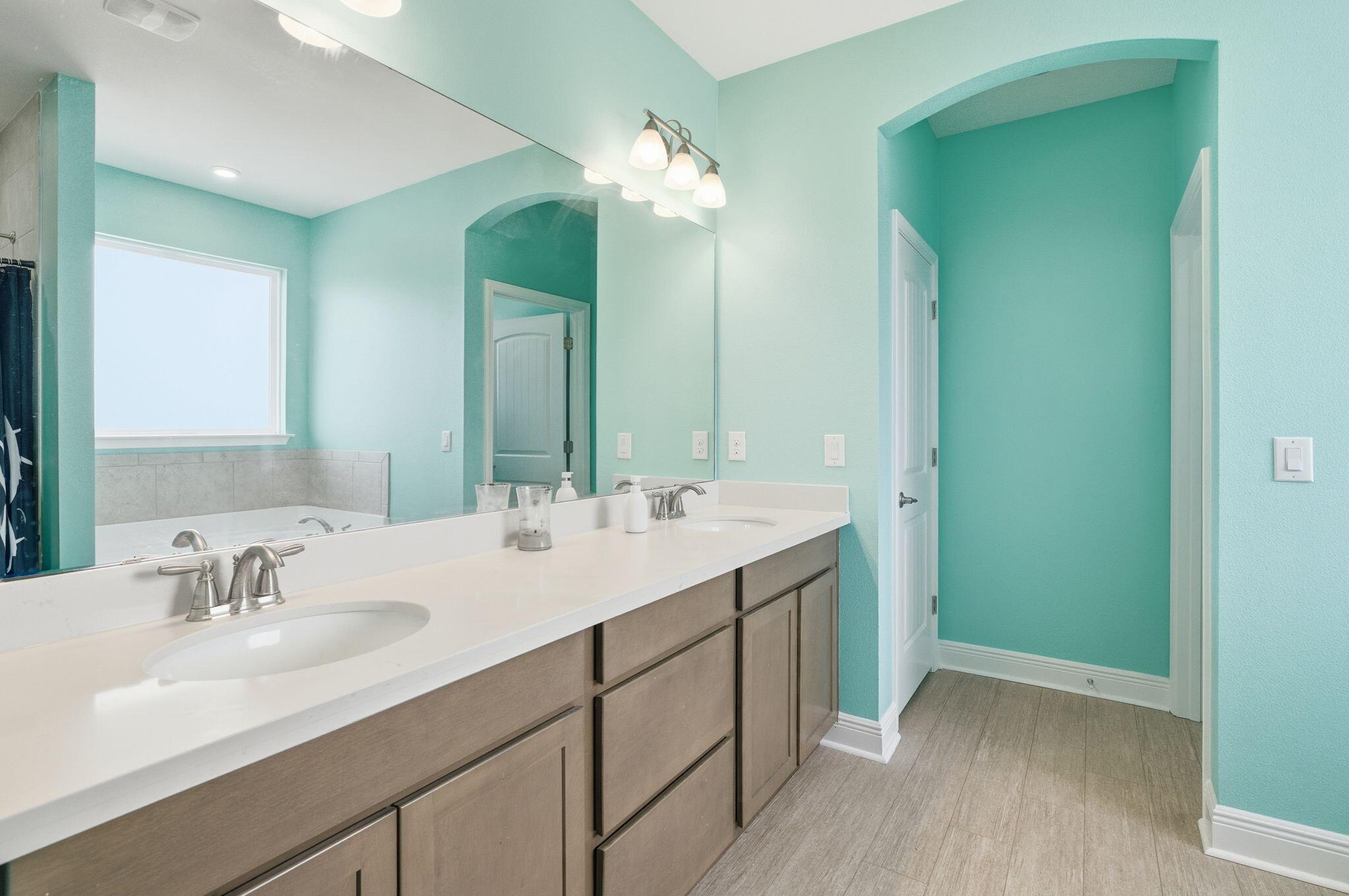 334 Tournament Lane Freeport, FL 32439 - Photo 16 of 27 a bathroom with a double vanity sink and a mirror