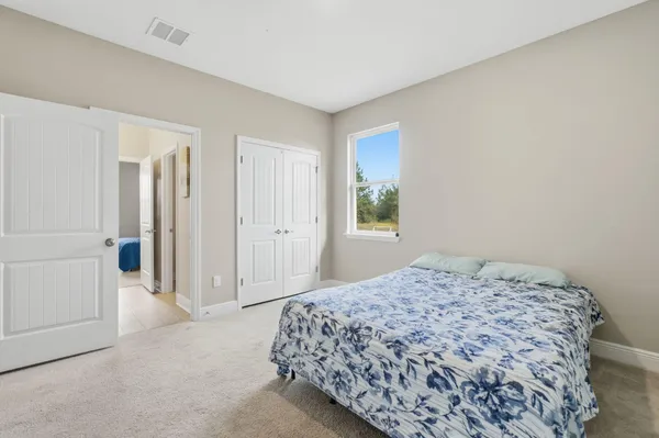 a bedroom with a bed and a book shelf