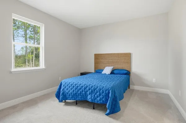 a bedroom with a bed and a lamp