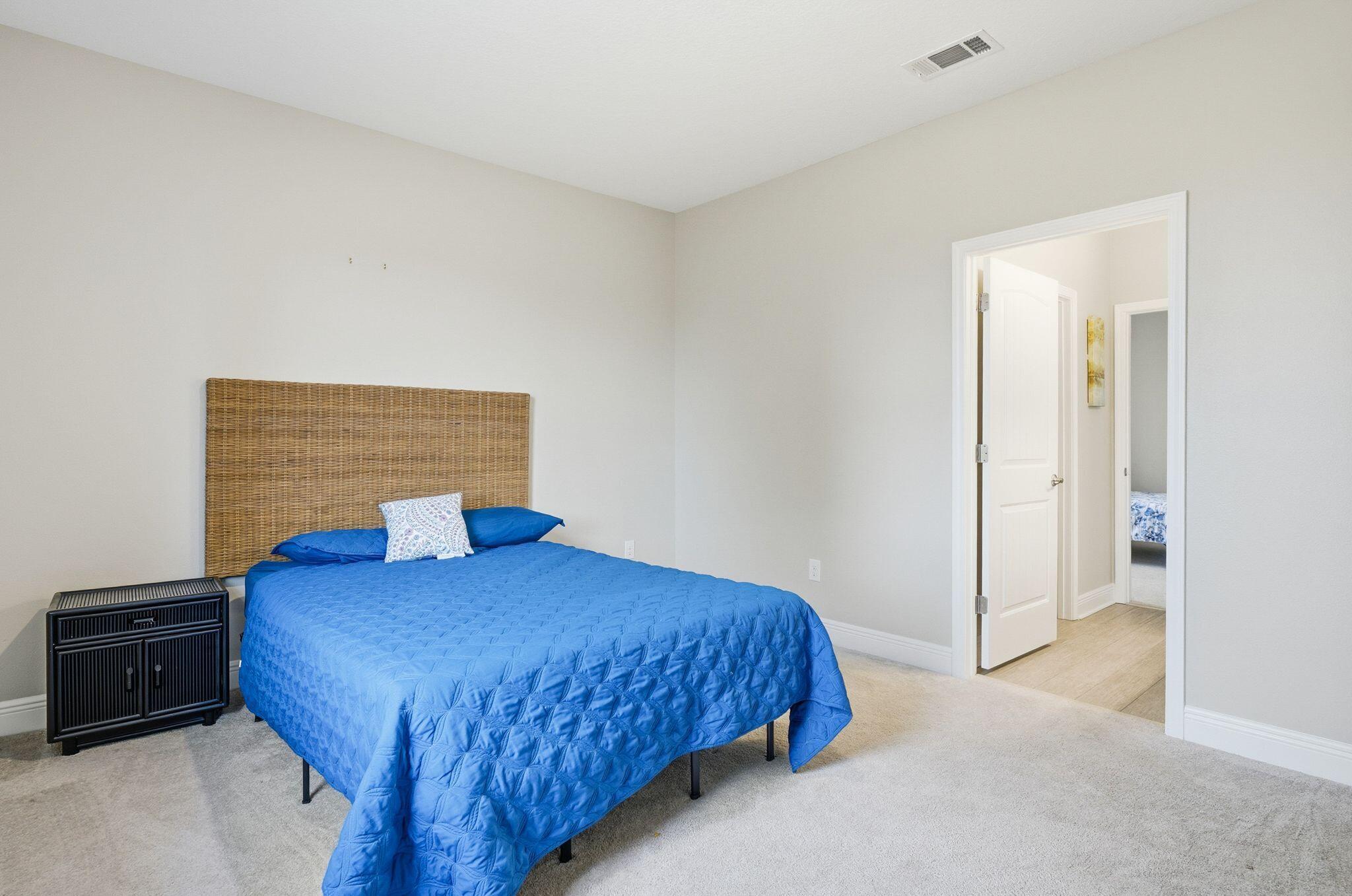 334 Tournament Lane Freeport, FL 32439 - Photo 23 of 27 a bedroom with a bed and a lamp