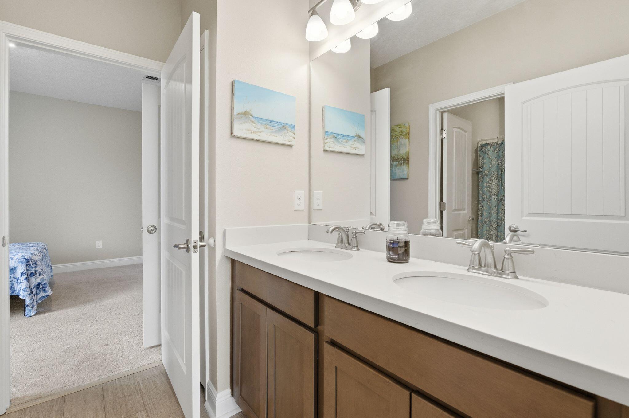 334 Tournament Lane Freeport, FL 32439 - Photo 25 of 27 a bathroom with a double vanity sink and a mirror