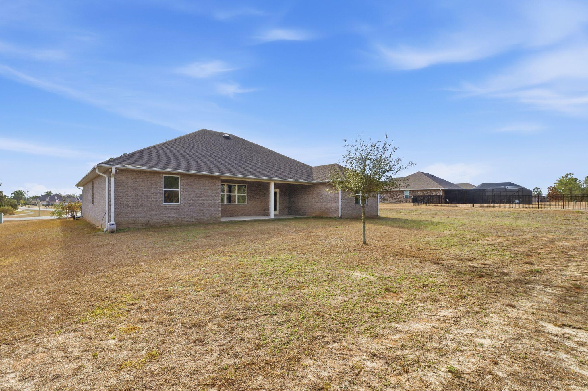334 Tournament Lane Freeport, FL 32439 - Photo 26 of 27 a house with garden in front of it