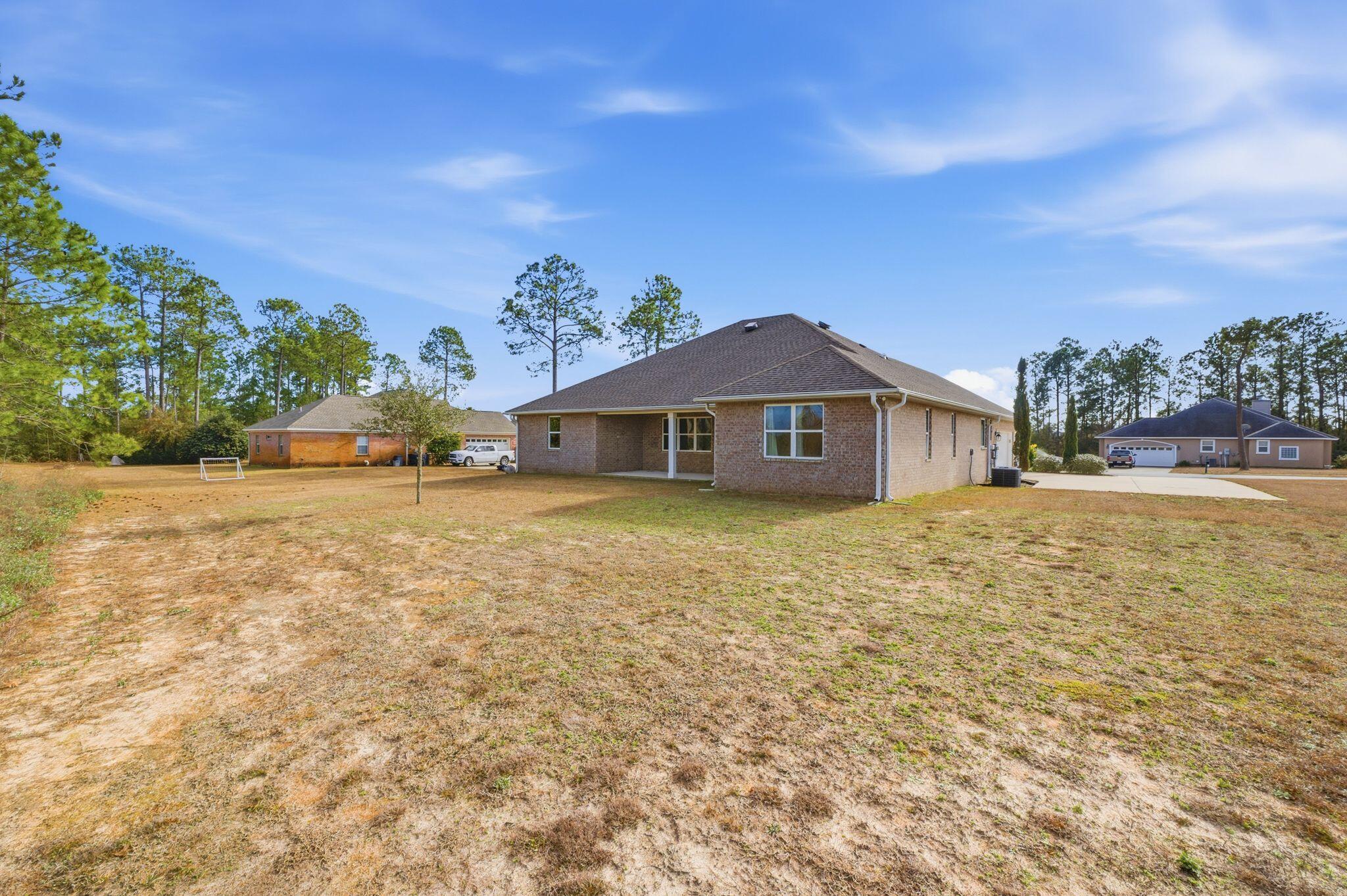 334 Tournament Lane Freeport, FL 32439 - Photo 27 of 27 a front view of a house with a yard