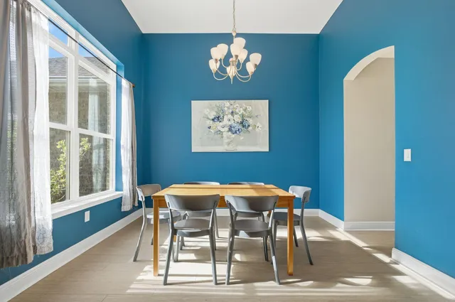 a dining room with furniture and chandelier