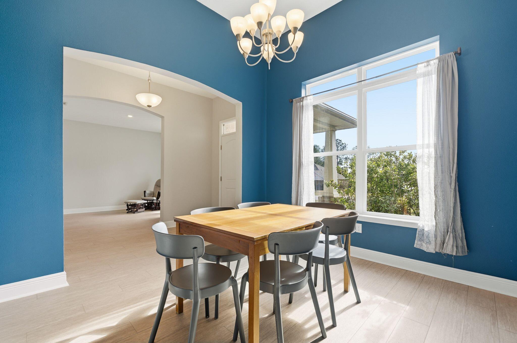 334 Tournament Lane Freeport, FL 32439 - Photo 8 of 27 a view of a dining room with furniture a chandelier and wooden floor
