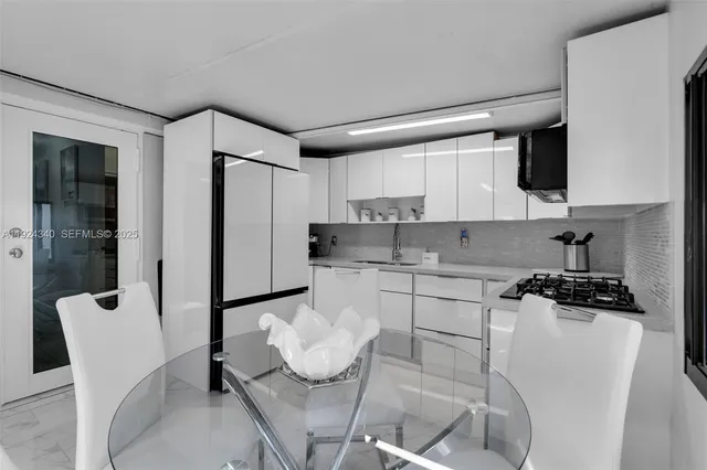 a kitchen with stainless steel appliances kitchen island granite countertop a sink and cabinets