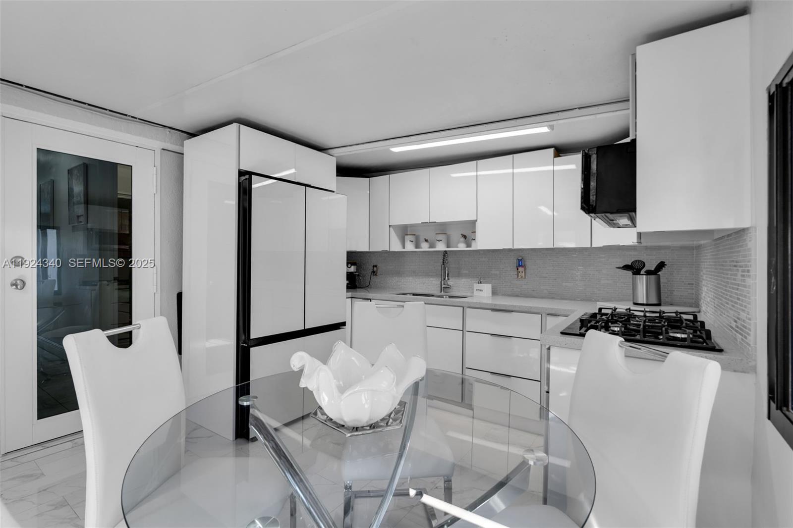 a kitchen with stainless steel appliances kitchen island granite countertop a sink and cabinets