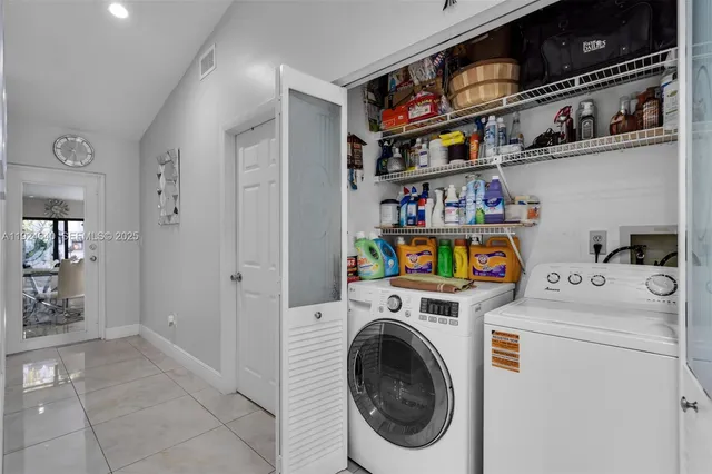 a view of storage and utility room with washer and dryer
