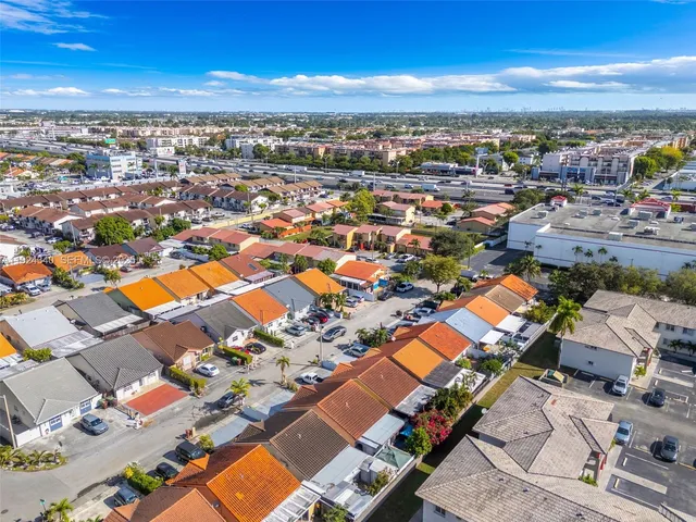 an aerial view of residential houses with outdoor space