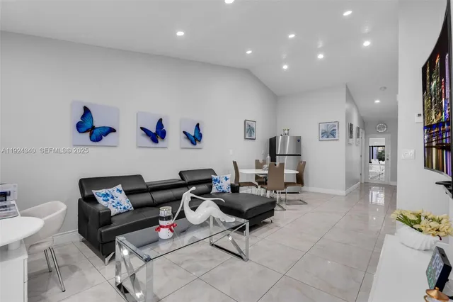 a living room with furniture and a gym equipment