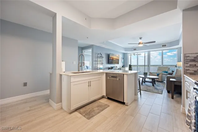 a kitchen with stainless steel appliances granite countertop a refrigerator a stove top oven a sink and dishwasher