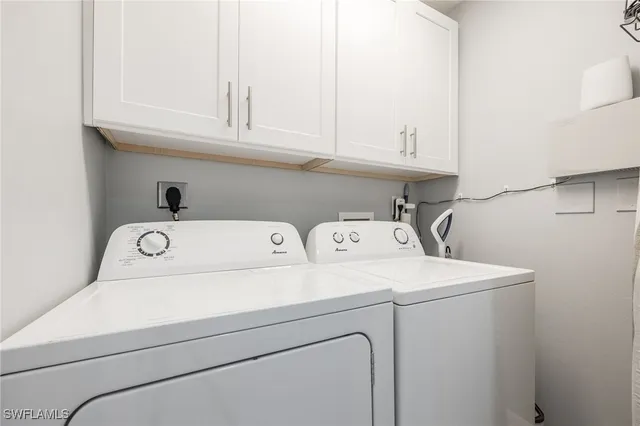 wooden floor with staircase and a living room with kitchen view