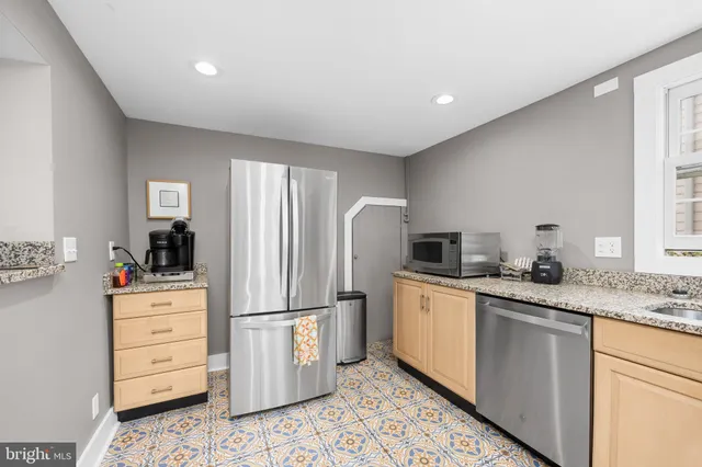 a living room with furniture rug and wooden floor
