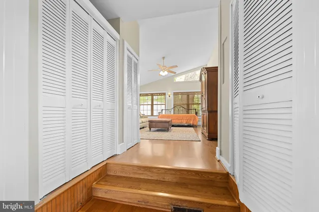 a bathroom with a granite countertop sink a mirror and a shower