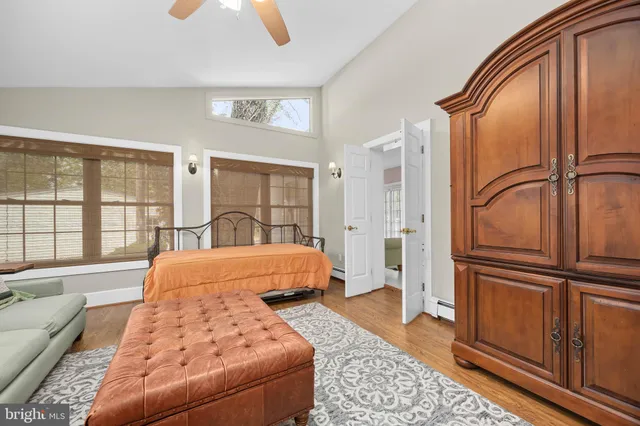 a bed sitting in a room next to a lamp