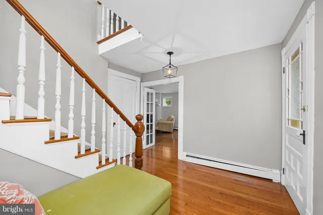 a large kitchen with stainless steel appliances granite countertop a lot of counter space and wooden floors