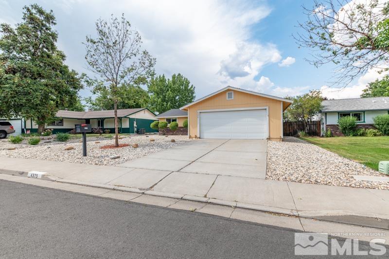 4375 Valdez Way Reno, NV 89502 - Photo 1 of 22 a front view of house with yard garage and trees