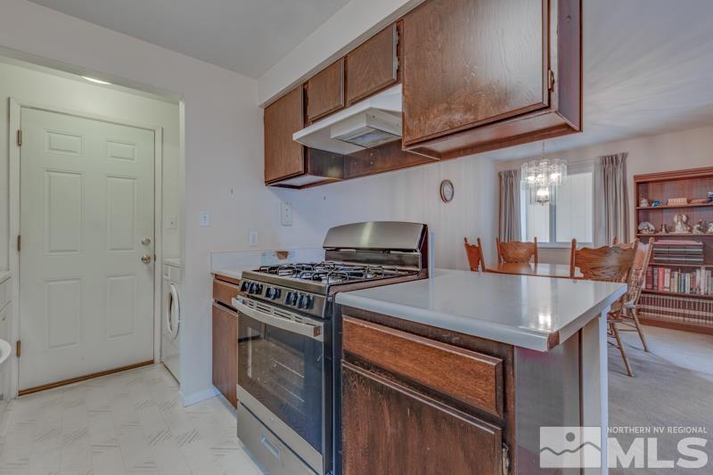 4375 Valdez Way Reno, NV 89502 - Photo 5 of 22 a kitchen with stainless steel appliances granite countertop a stove and a microwave