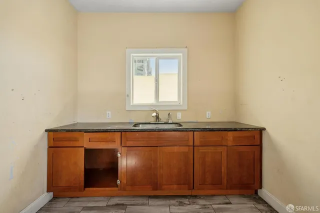 a room with wooden floor and a sink