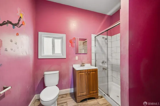 a bathroom with a sink toilet vanity and shower