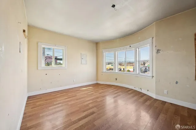 wooden floor in an empty room with a window